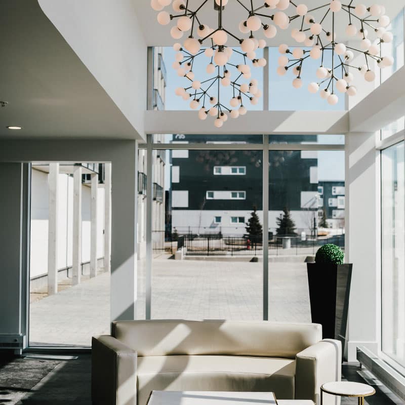 A clean lobby to a building looking out on a white brick courtyard